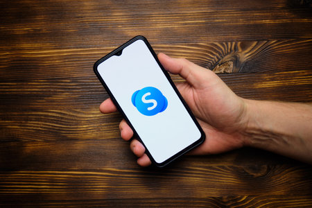 Skype messenger logo on a mobile phone screen. russia, st.petersburg, 8 december 2020.のeditorial素材