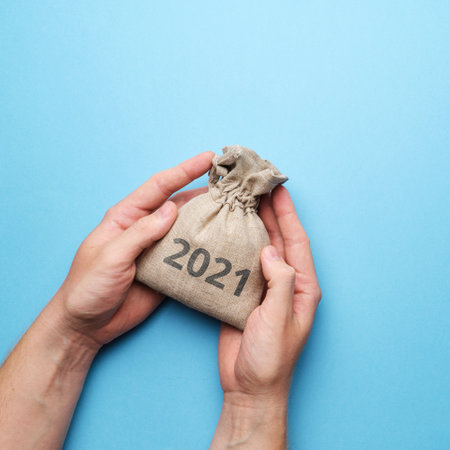 The concept of saving and protecting money in hands in 2021.の写真素材