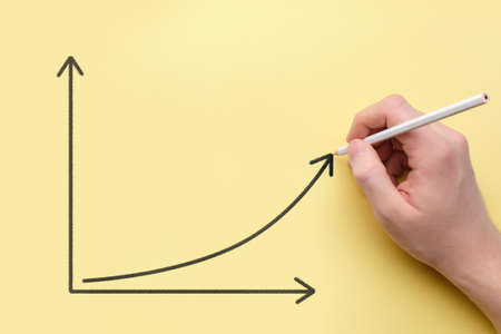 Person draws a graph of growth with a pencil. Success conceptの写真素材