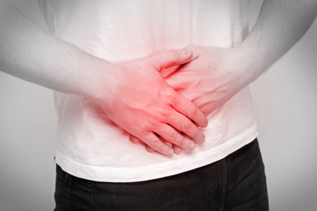 Person man experiencing pain in the lower abdomen.