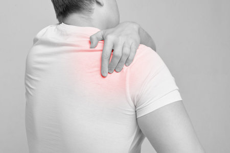 The person experiences pain from a stretched back and massages it.