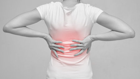 The person is massaging the back because of the feeling of pain from sciatica and neurology