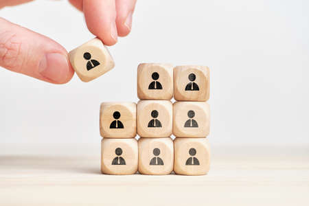Teambuilding and teamwork concept on wooden cubes with abstract personas employee.の写真素材
