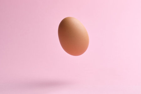 Flying egg on pink background. Happy easter conceptの写真素材