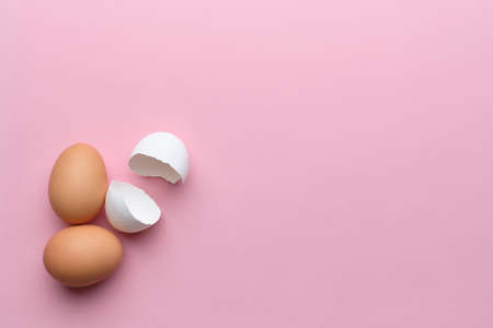 Broken and whole egg with top view and copy space. Happy easter conceptの写真素材