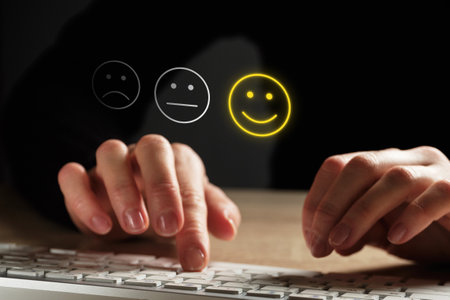 Good mood concept made of emoticon and rating. The girl puts an assessment using the keyboardの写真素材