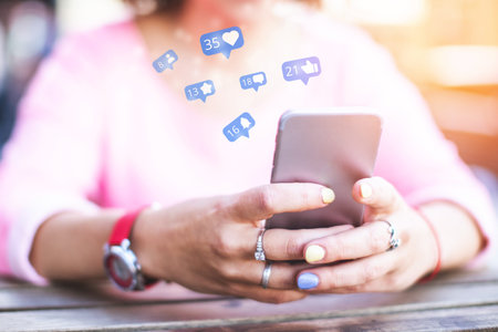 A girl uses a smartphone while spending time in social networks, getting likes and subscribers.