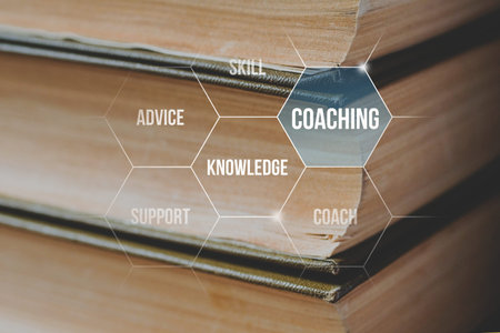 coaching and training concept on the background of a stack of books.