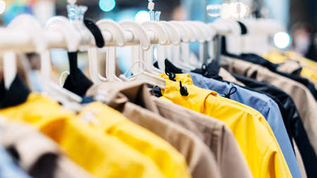 Summer nylon jackets hang on hangers in the showroom.の写真素材