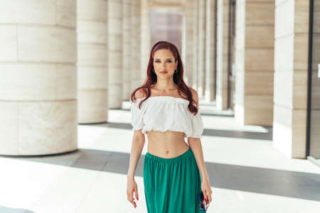 Redheaded Caucasian girl about thirty years old portrait in summertime looking at the camera.の写真素材