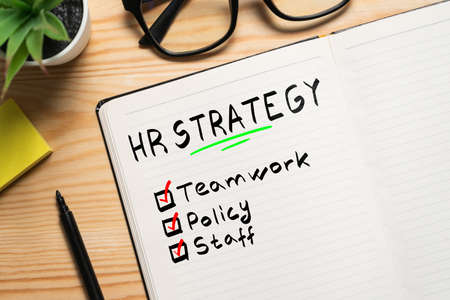Conceptual plan development hr strategy with notes in notebook.の写真素材