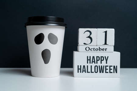 A ghost from a craft mug next to the October calendar. Halloween holidayの写真素材