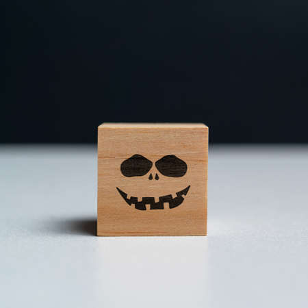Evil face on a wooden cube. Halloween holidayの写真素材