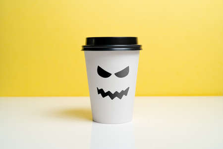 A craft coffee cup with a wicked smile. Halloween holidayの写真素材
