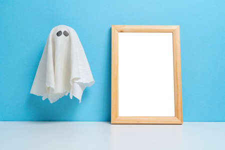 An abstract ghost next to a wooden frame with copy space. Halloween holidayの写真素材