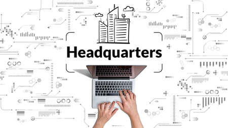 Business acronym HQ or Headquarters. Person works at laptop.の写真素材