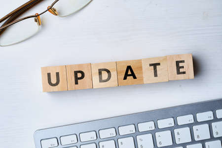 The concept of software update written on wooden cubes next to the keyboardの写真素材