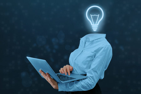 Concept idea and its development. Person with a laptop and a light bulb instead of a head
