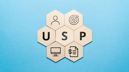 Acronym USP or Unique Selling Proposition. Abstract icons and text on wooden formsの写真素材
