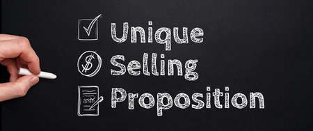 Acronym USP or Unique Selling Proposition. Person drawing with chalk on a blackboard.の写真素材
