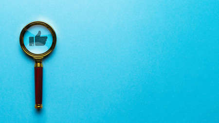 The concept of social research and approval. Thumb up icon with magnifying glassの写真素材