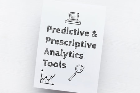 Concept Predictive Prescriptive Analytics Tools. Text on a piece of paper with icons