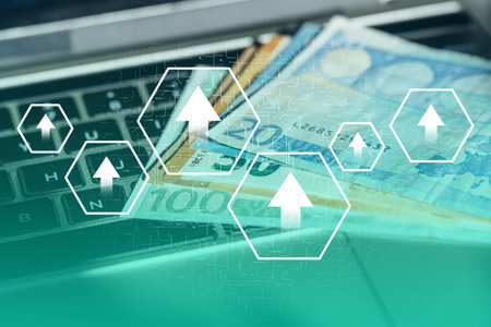 Growth concept. Abstract image with up arrows on the background of money with a laptop.