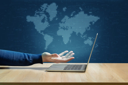 Globalization concept and world map over hand and laptop
