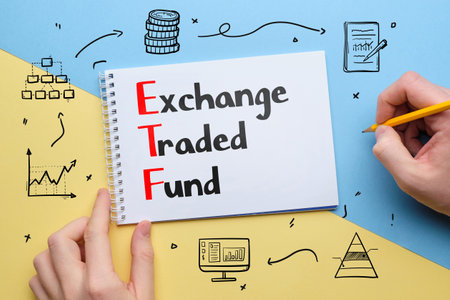 Concept ETF or Exchange traded fund. Business acronym. Text in notepad with icons.の写真素材