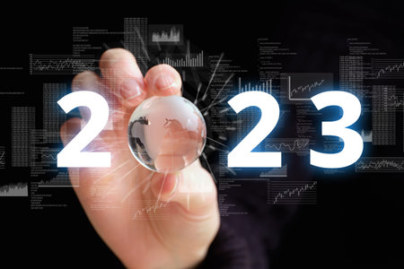 The concept of the new year 2023. Abstract earth globe with world map in person hand.