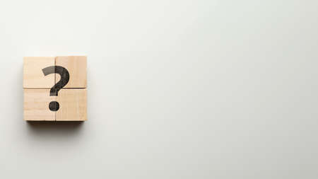 Question mark concept or FAQ. Sign on wooden cubes with copy space.の写真素材