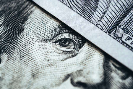 Macro face and eyes of a hundred dollar bill. money and finance conceptの写真素材