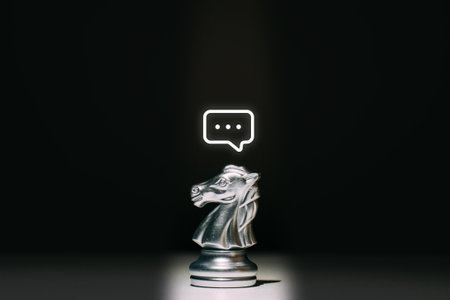 A chess piece of a horse with a message icon above it. Concept of communication and HR.の写真素材