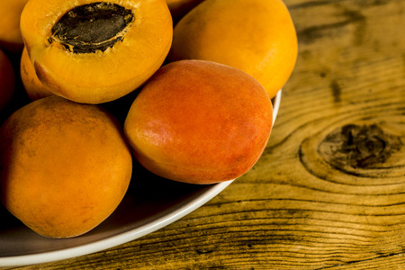 Apricots on the old wooden tableの写真素材