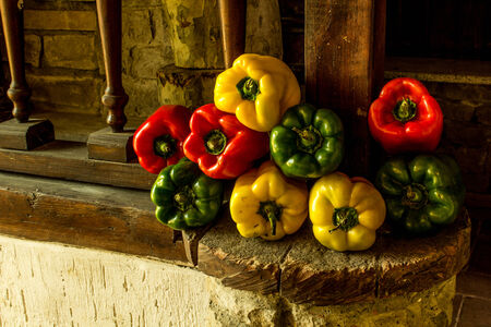 Organic peppers on a rustic stoneの写真素材