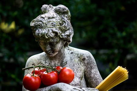 Statue with spaghetti and tomatoの写真素材