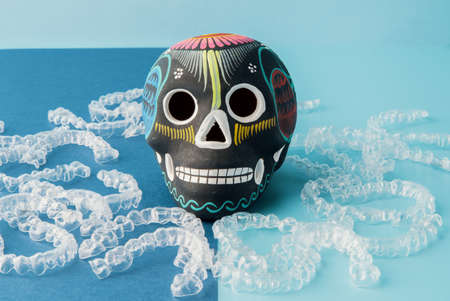 Invisible orthodontia with Mexican skull on blue backgroundの写真素材
