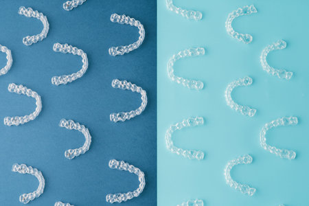 Transparent and invisible dental aligner for orthodontic treatment on blue and black background