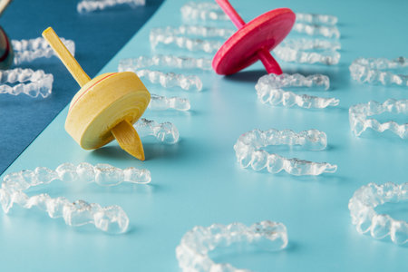 Transparent and invisible dental aligner for orthodontic treatment with fun colored spinning tops