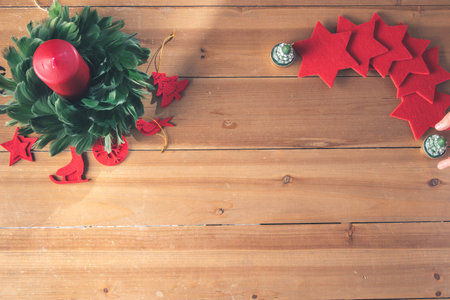 Christmas decoration on a wooden craft table in a family's home for Christmas and New Years Eveの写真素材