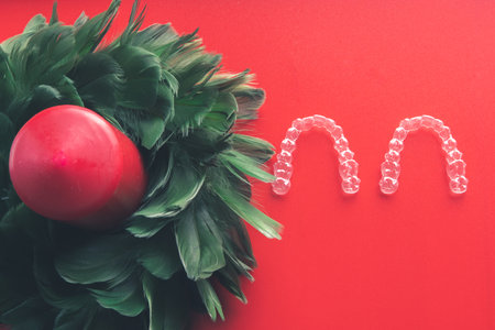 Many invisible dental aligners or transparent aligners on red background. Aesthetic orthodontic treatment that the dentist does in the dental clinic.の写真素材