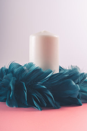 Cute Christmas candle with creative feather wreathの写真素材