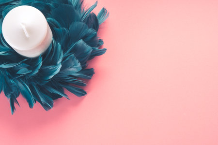 Creative and cheerful blue feather crown on pink baseの写真素材