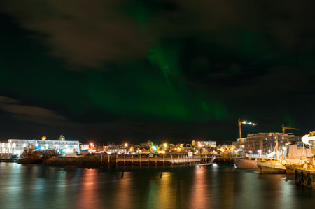 Aurora borealis in Reykjavik harbor in Icelandの写真素材