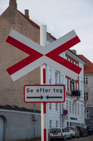 Railway crossing sign in Denmark saying "Look for trains"の写真素材