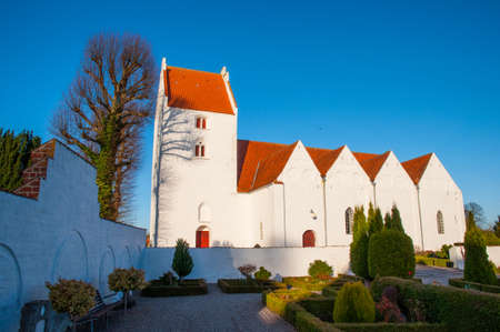 Church in countryside town of Mern in Denmark on a sunny autumn dayの写真素材