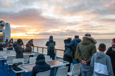 Fehmarn Belt Germany - January 2. 2018: Tourists enjoying the sunset from the deck of a ferryのeditorial素材