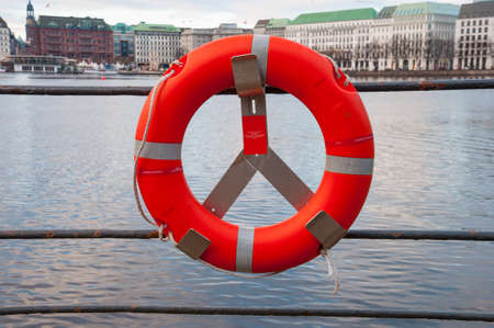 Lifebuoy an the edge of a lake in the cityの写真素材