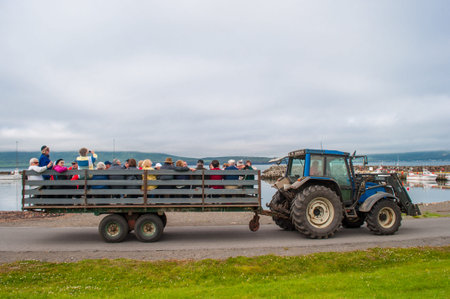 Hrisey Iceland - August 1. 2010: Tourists on a trailer behind a tractor
