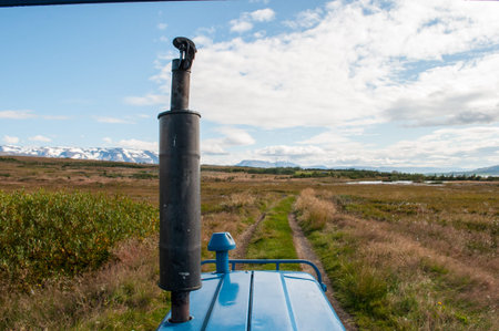 Blue tractor on a track in the Icelandic Countrysideの写真素材